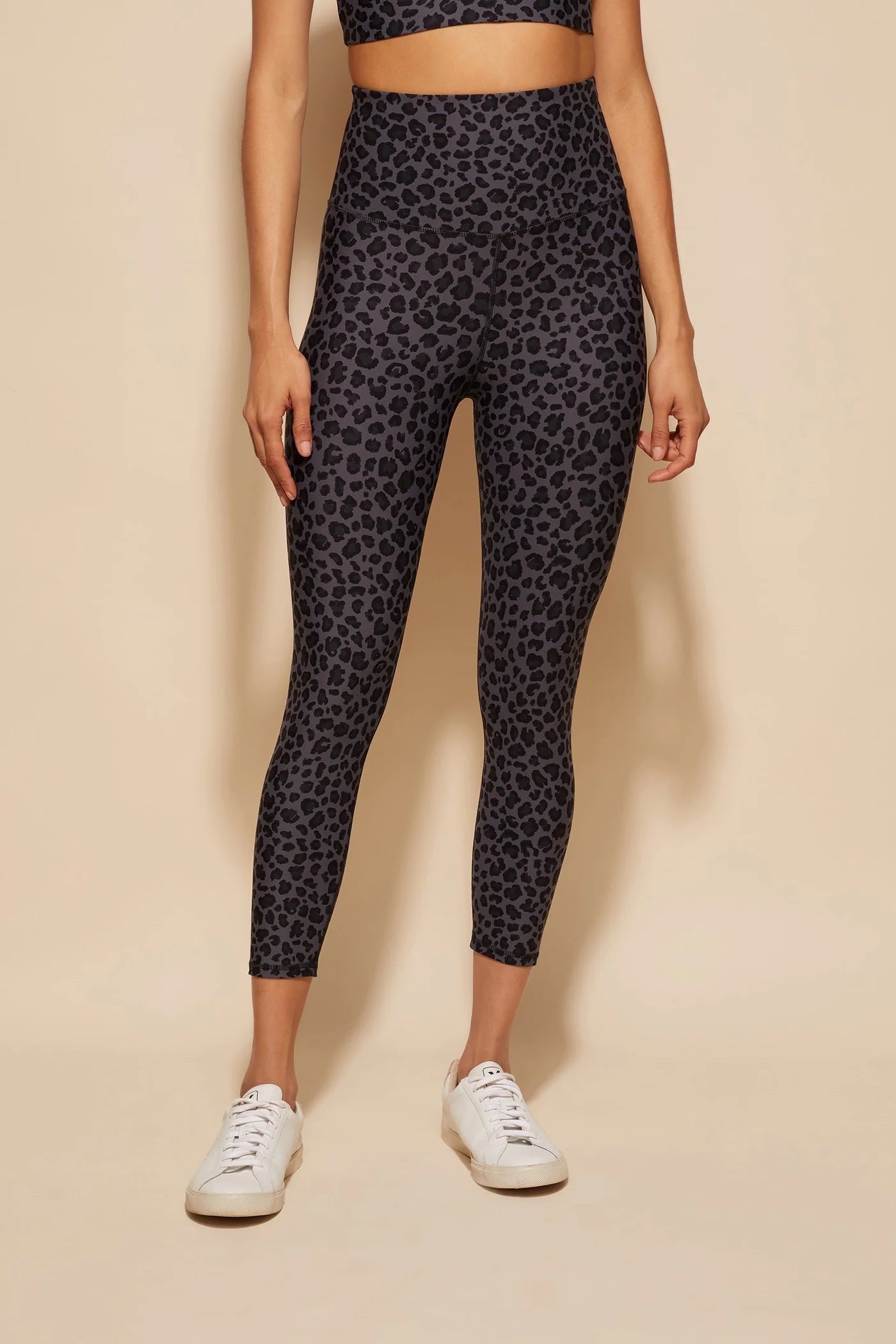 A pair of DK Active Utopia Print Leopard Smoke tights on a female model, featuring a high waist and leopard print pattern.
